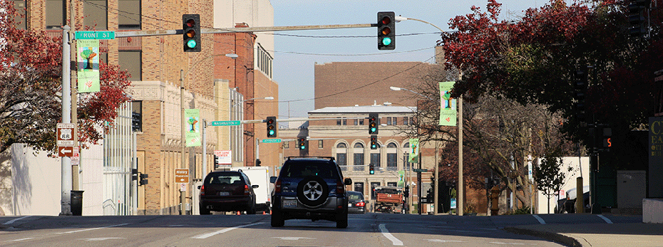 US 51 from Olive Street facing north with cars driving north and several stop lights that are green